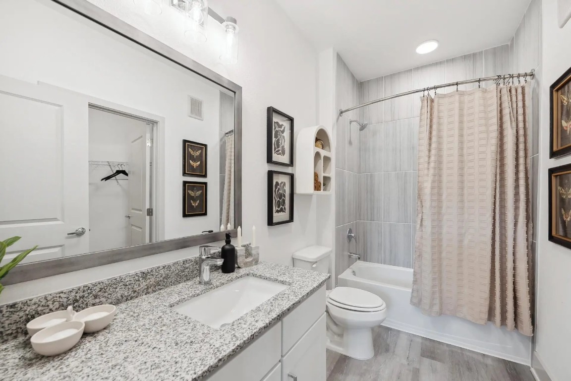 945 Blakey Lane, Unit 10304 Bastrop, TX 78602 - Photo 12 of 29 a bathroom with a granite countertop sink toilet and shower