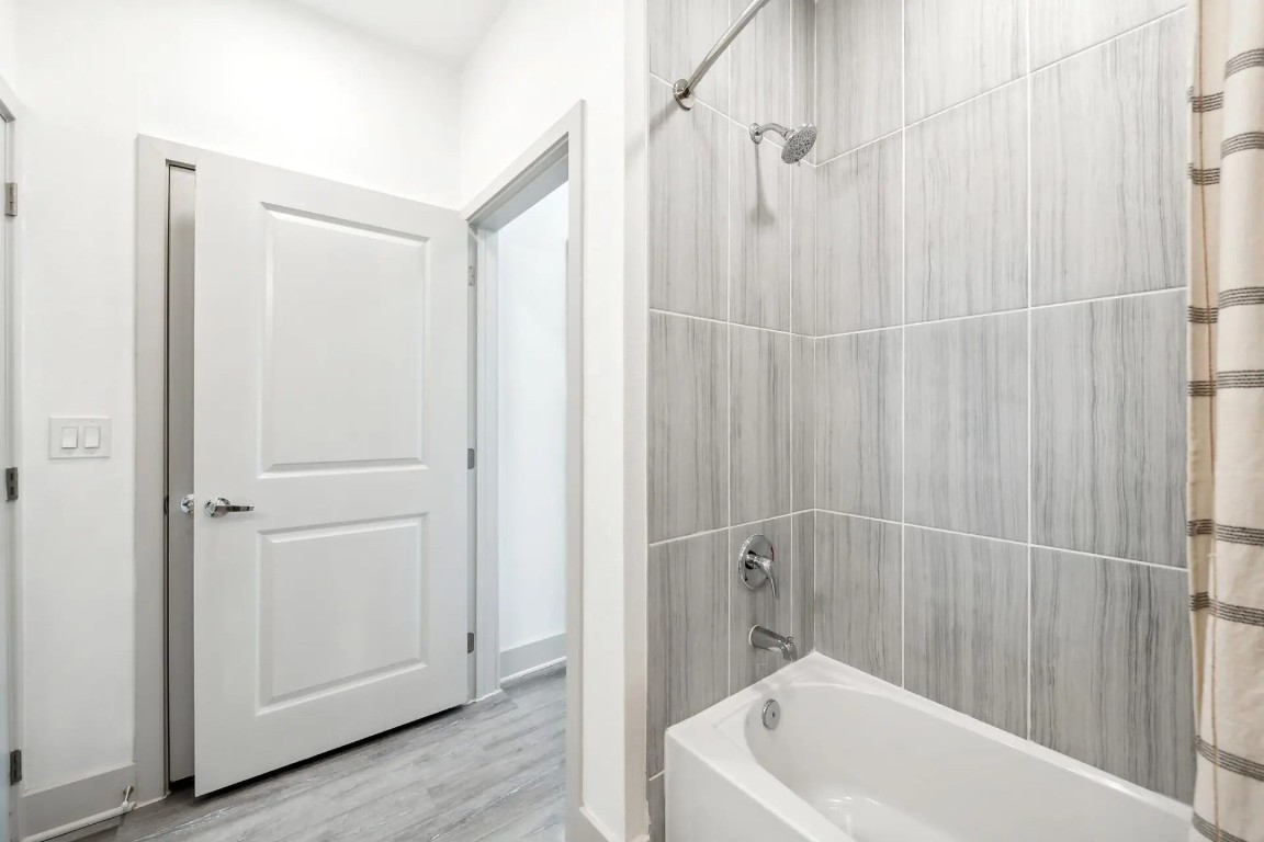 945 Blakey Lane, Unit 10304 Bastrop, TX 78602 - Photo 15 of 29 a bathroom with a white bath tub