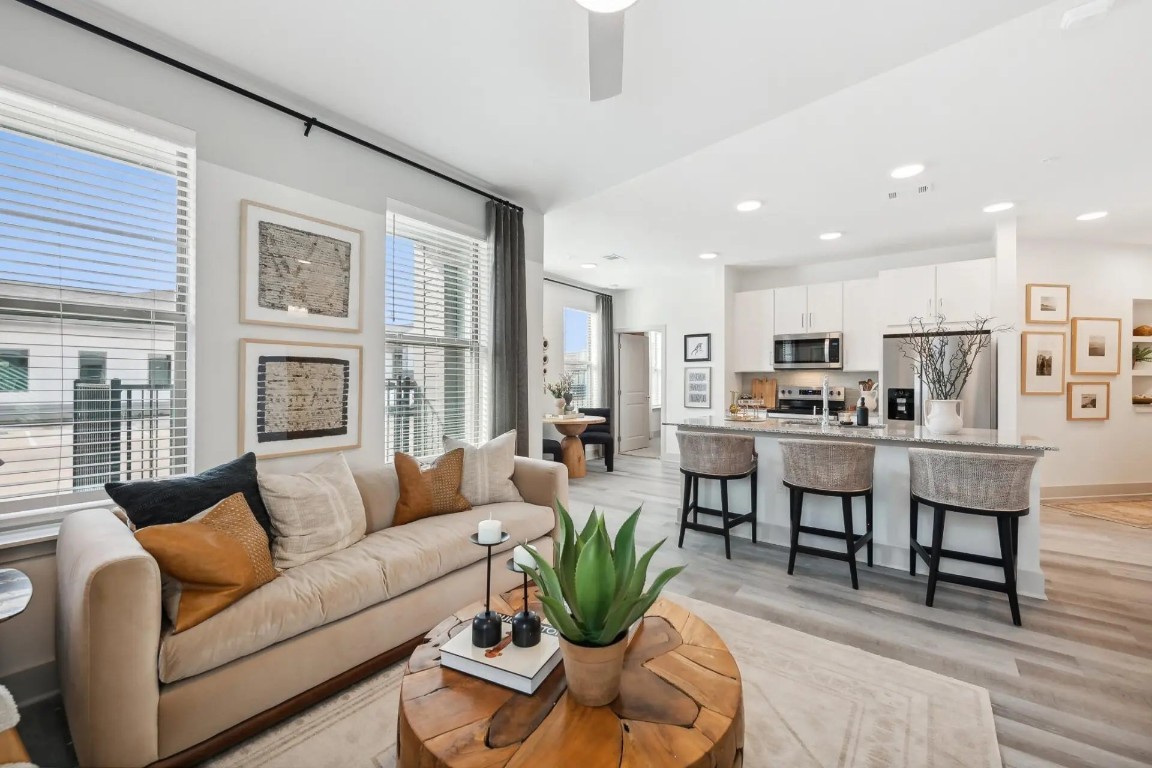 945 Blakey Lane, Unit 10304 Bastrop, TX 78602 - Photo 17 of 29 a living room with furniture wooden floor and kitchen view