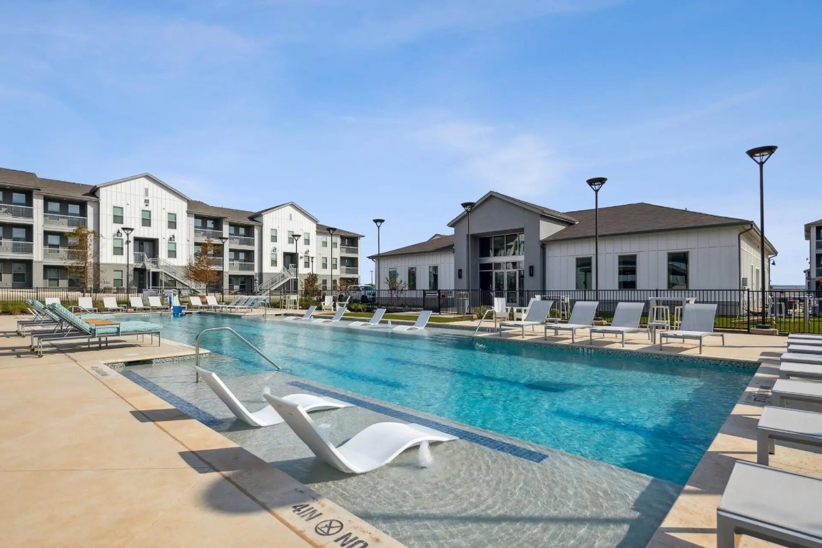 945 Blakey Lane, Unit 10304 Bastrop, TX 78602 - Photo 28 of 29 a front view of a house with swimming pool having outdoor seating