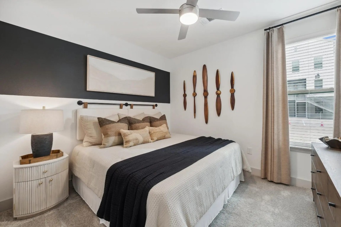 945 Blakey Lane, Unit 10304 Bastrop, TX 78602 - Photo 3 of 29 a bedroom with a bed and a flat screen tv