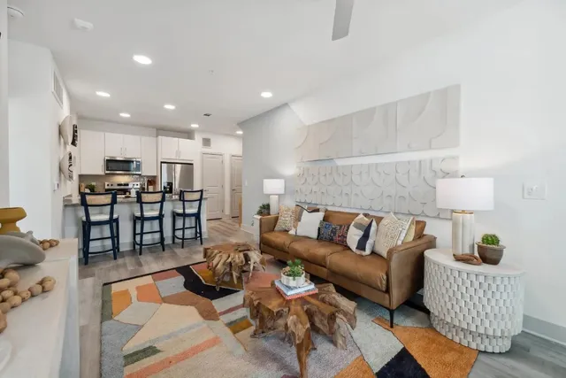 a living room with furniture kitchen and a table