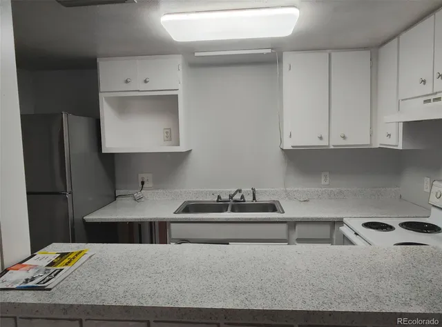 a kitchen with a sink and cabinets