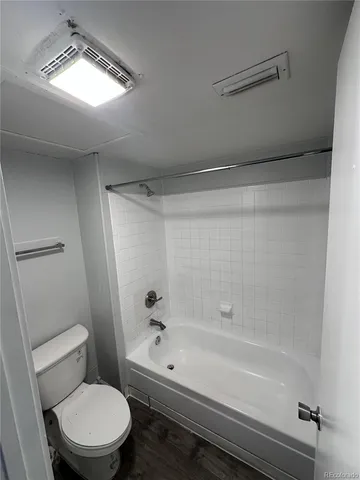 a bathroom with a toilet and a tub