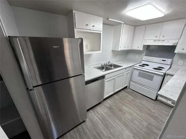 a kitchen with a stove a refrigerator and a refrigerator