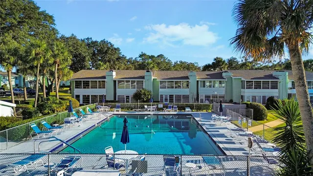 a view of a house with a backyard porch and sitting area