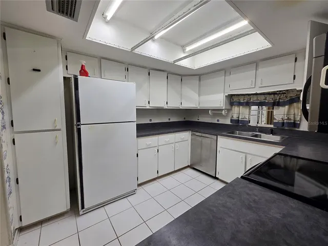 a kitchen with a sink a stove and cabinets