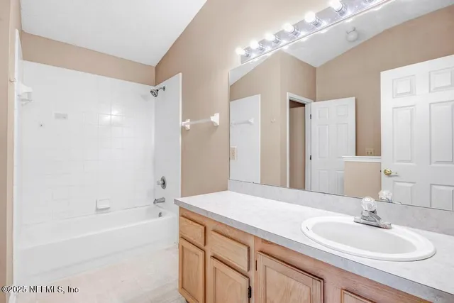 a bathroom with a sink a toilet and a large mirror