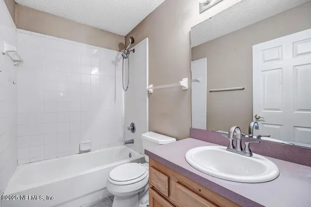 an empty room with a window and a ceiling fan