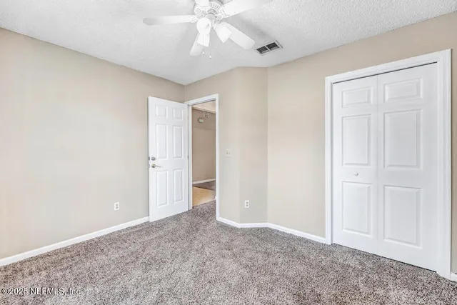 a view of a lake with a yard and mountain view