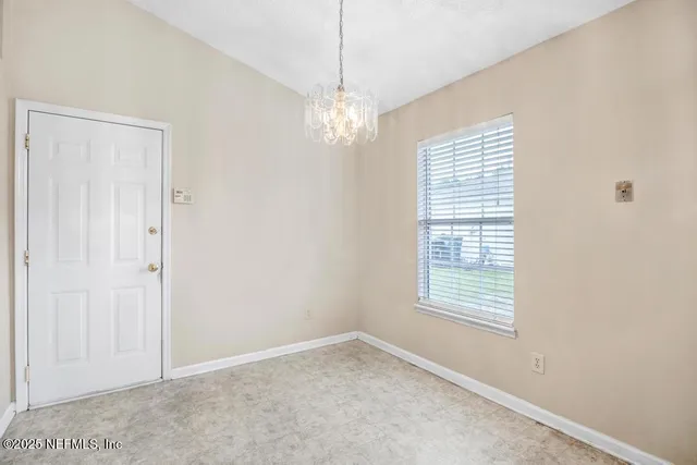 a large white kitchen with a refrigerator a sink dishwasher a oven with white cabinets and countertops