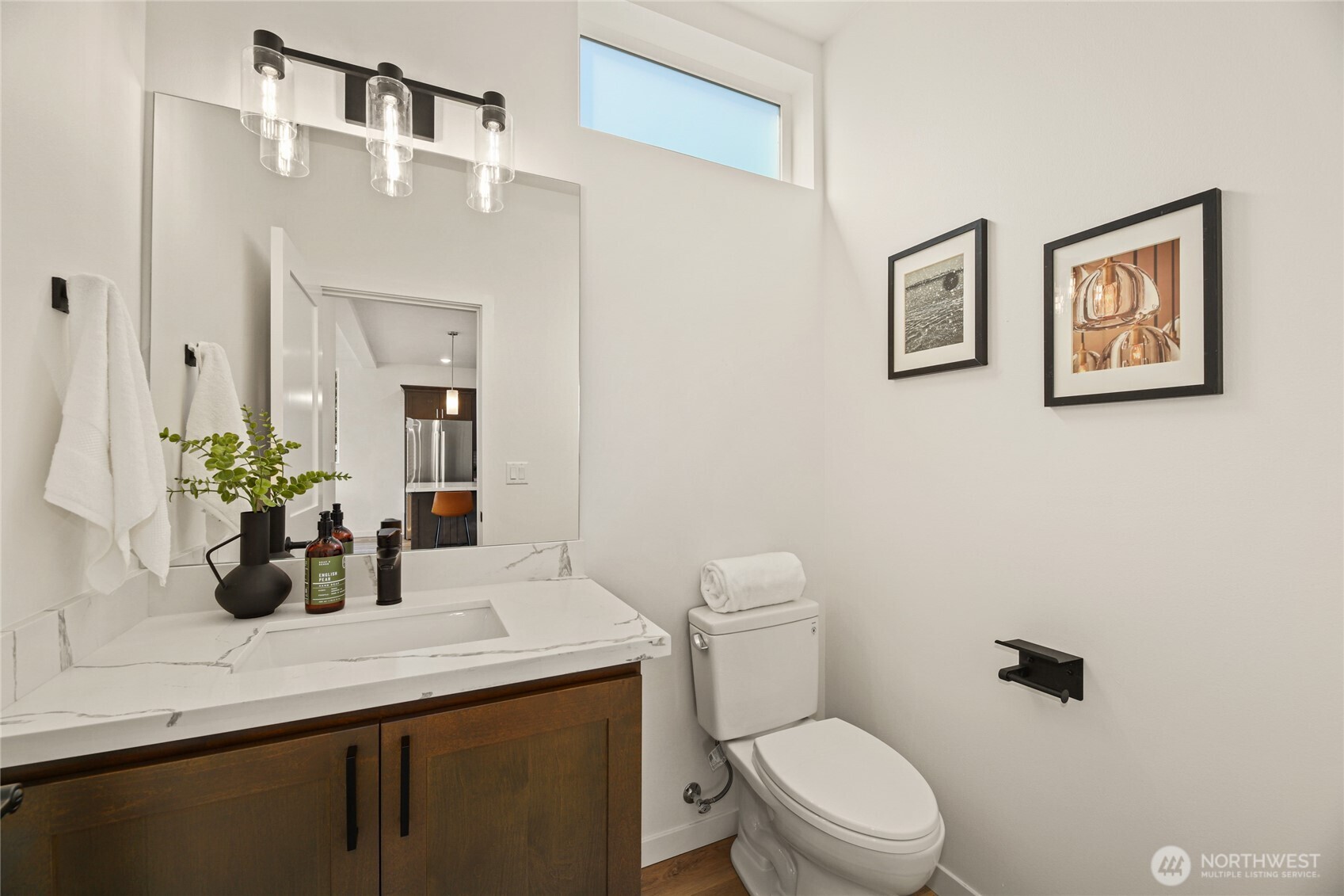 12037 Fremont Avenue North, Unit 1 Seattle, WA 98133 - Photo 15 of 30 a bathroom with a sink a toilet and mirror