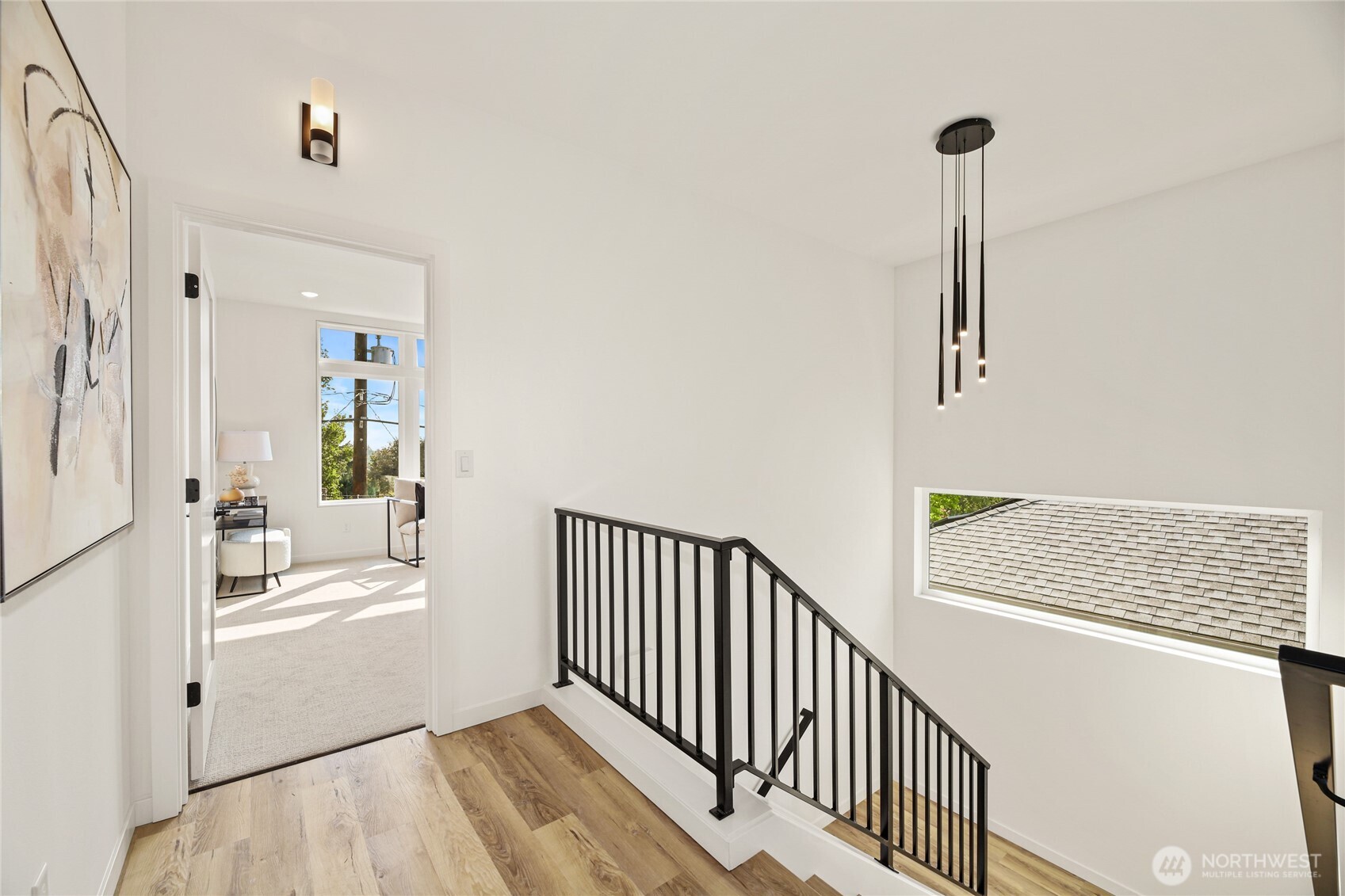 12037 Fremont Avenue North, Unit 1 Seattle, WA 98133 - Photo 18 of 30 a view of a hallway with wooden floor and a window