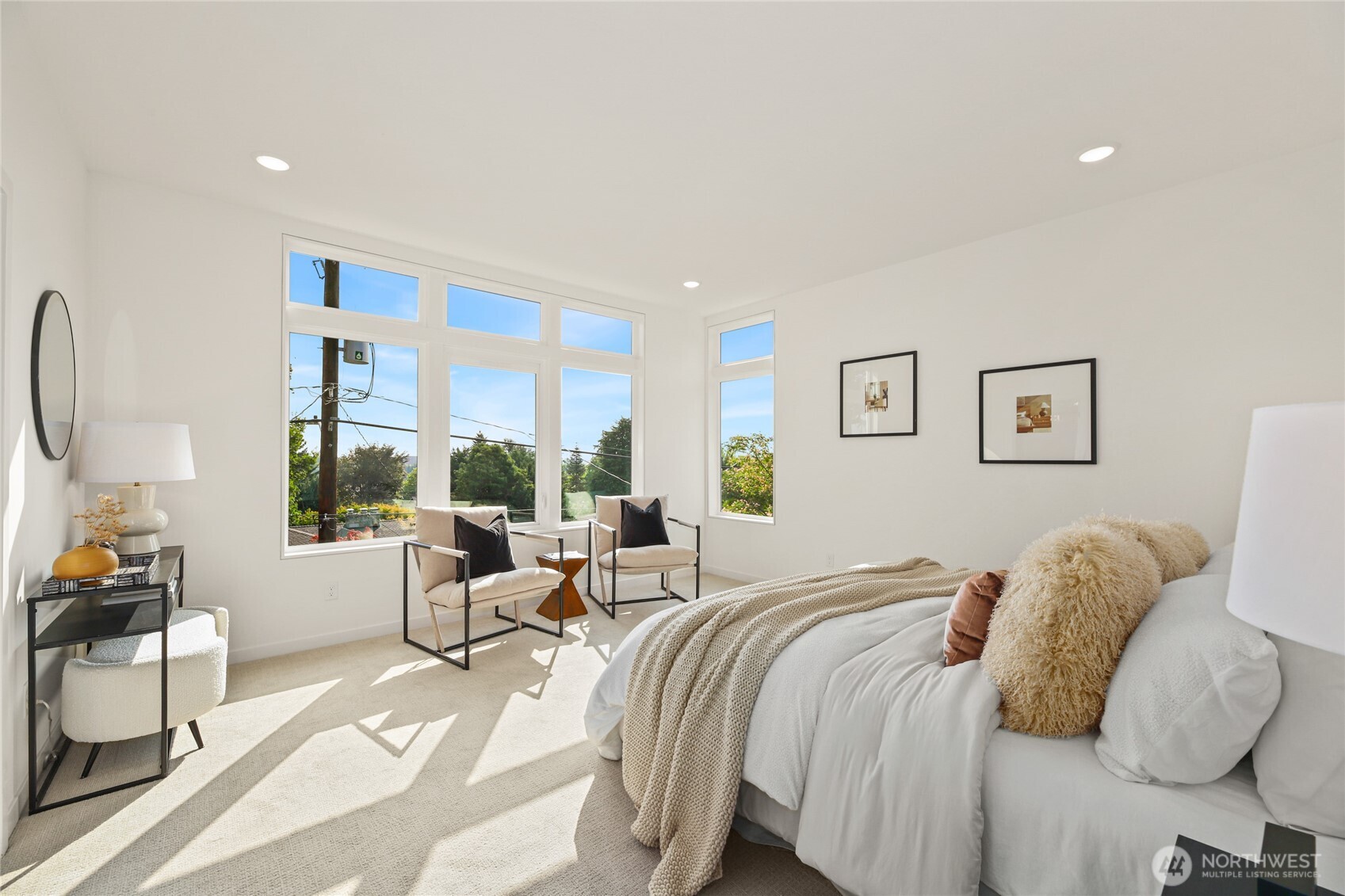 12037 Fremont Avenue North, Unit 1 Seattle, WA 98133 - Photo 19 of 30 a bedroom with a bed and a large window
