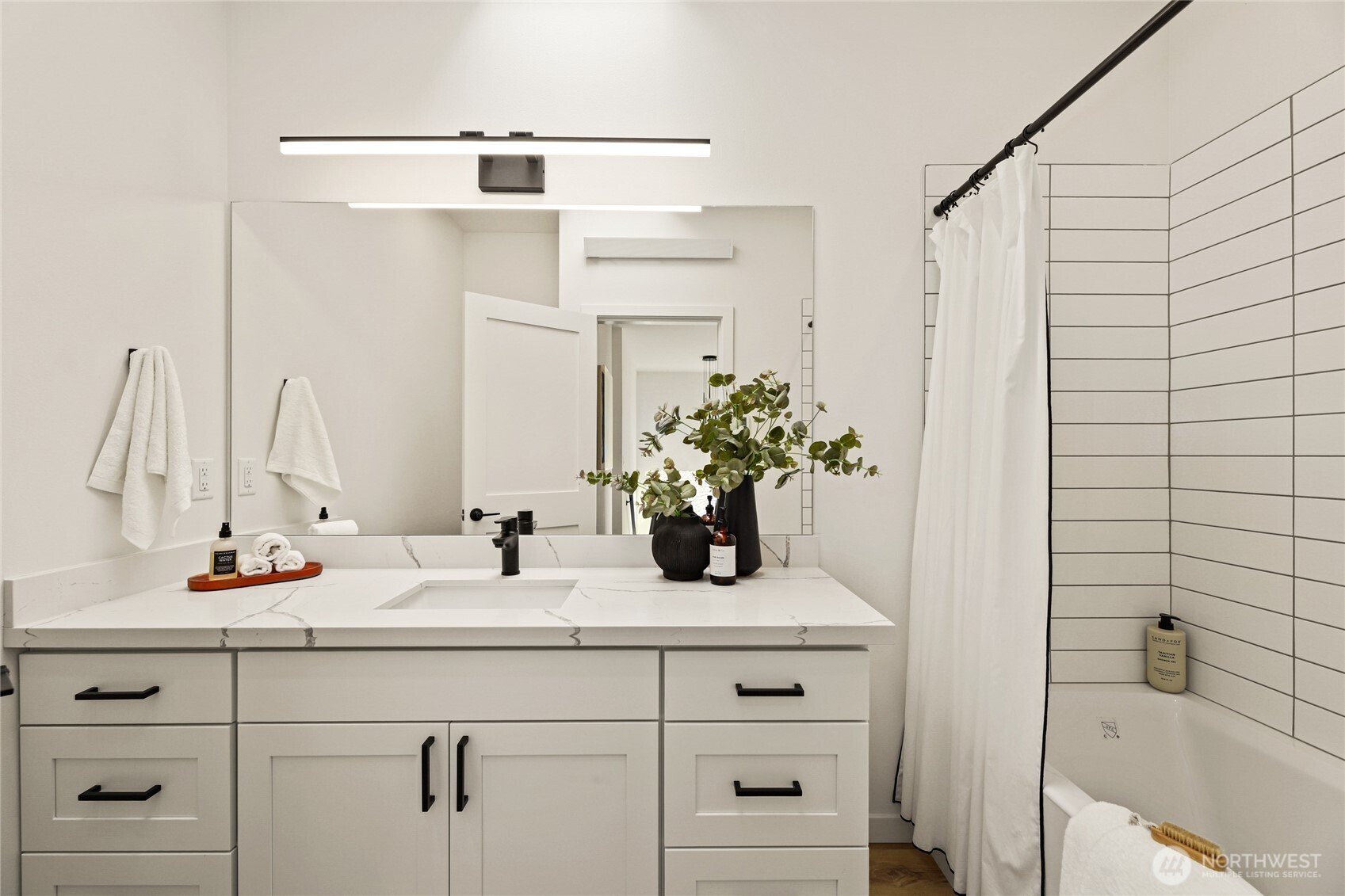 12037 Fremont Avenue North, Unit 1 Seattle, WA 98133 - Photo 24 of 30 a bathroom with a sink and a mirror