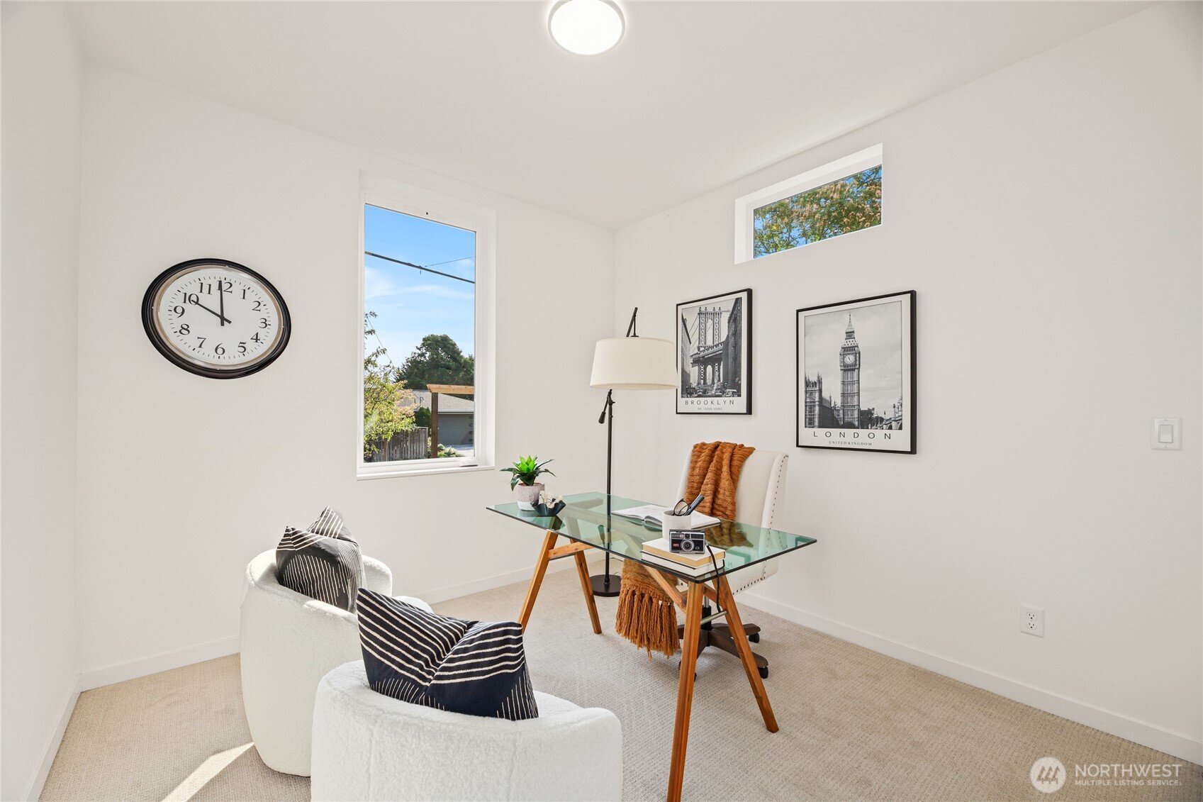 12037 Fremont Avenue North, Unit 1 Seattle, WA 98133 - Photo 26 of 30 a living room with furniture a clock and a window