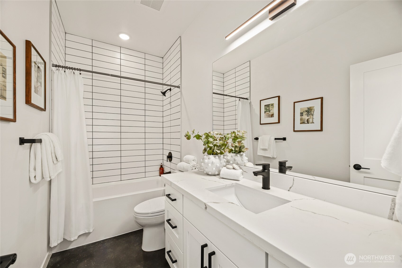 12037 Fremont Avenue North, Unit 1 Seattle, WA 98133 - Photo 27 of 30 a bathroom with a sink toilet and shower