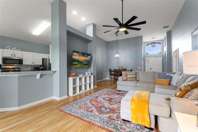 a living room with furniture and a chandelier