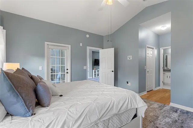 a dining room with furniture a potted plant and a floor to ceiling window