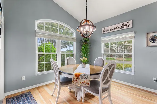 a kitchen with a sink dishwasher a stove a refrigerator and microwave with wooden floor