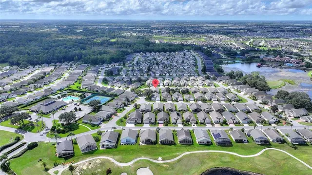 an aerial view of a house with a yard and lake view
