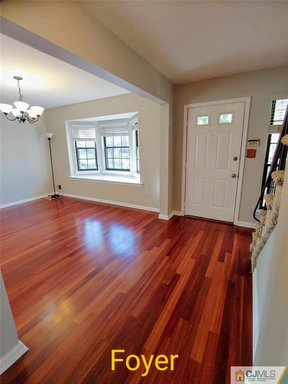 3305 Stonehedge Road Edison, NJ 08820 - Photo 2 of 14 a view of an empty room with wooden floor and a window