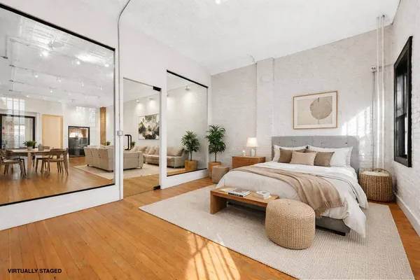 a spacious bedroom with a balcony a bed and a view of living room