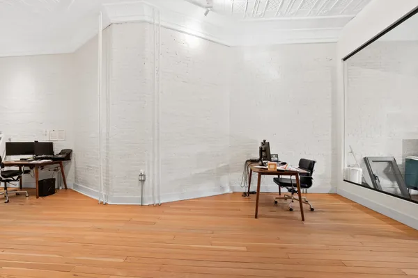 a workspace with furniture and wooden floor