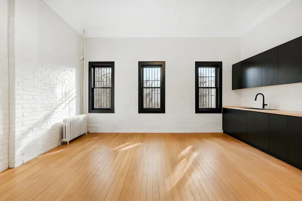 a view of a room with window and wooden floor