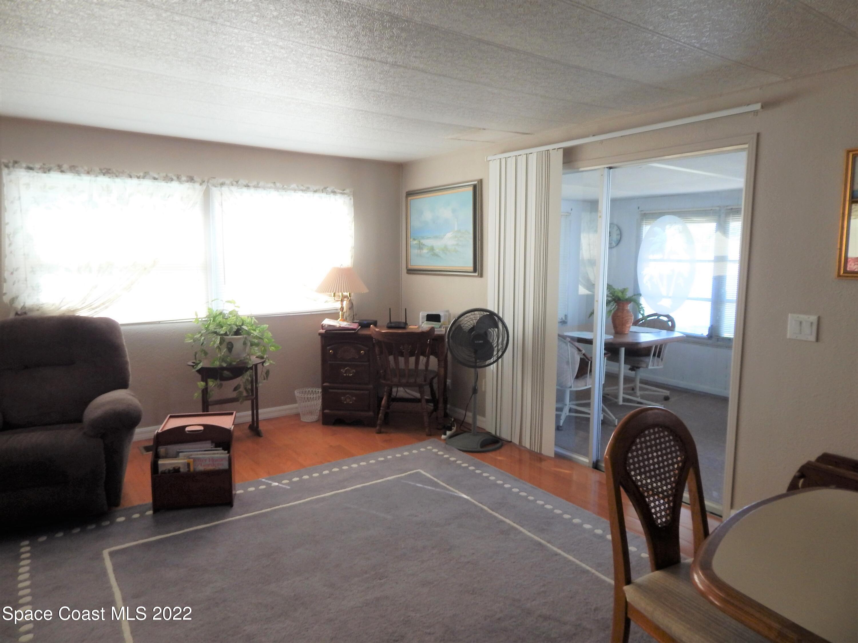 3112 Tangelo Drive Northeast Palm Bay, FL 32905 - Photo 12 of 42 a livingroom with furniture and a window
