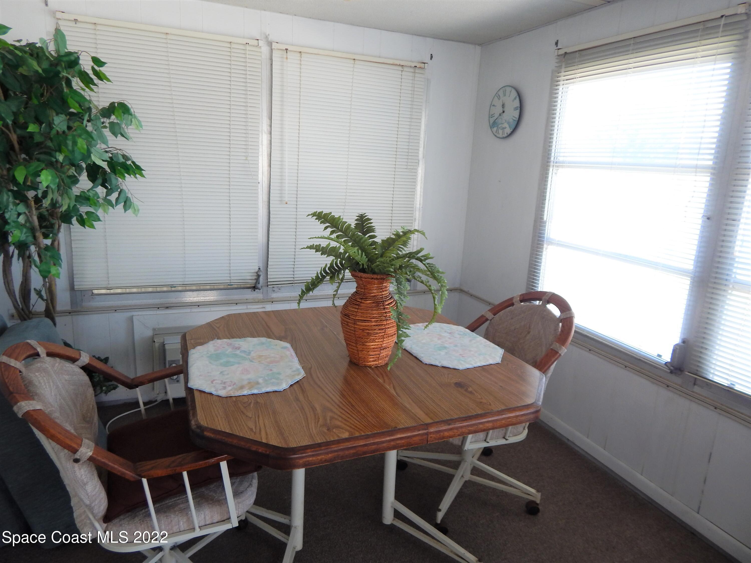 3112 Tangelo Drive Northeast Palm Bay, FL 32905 - Photo 14 of 42 a dining room with furniture and potted plants