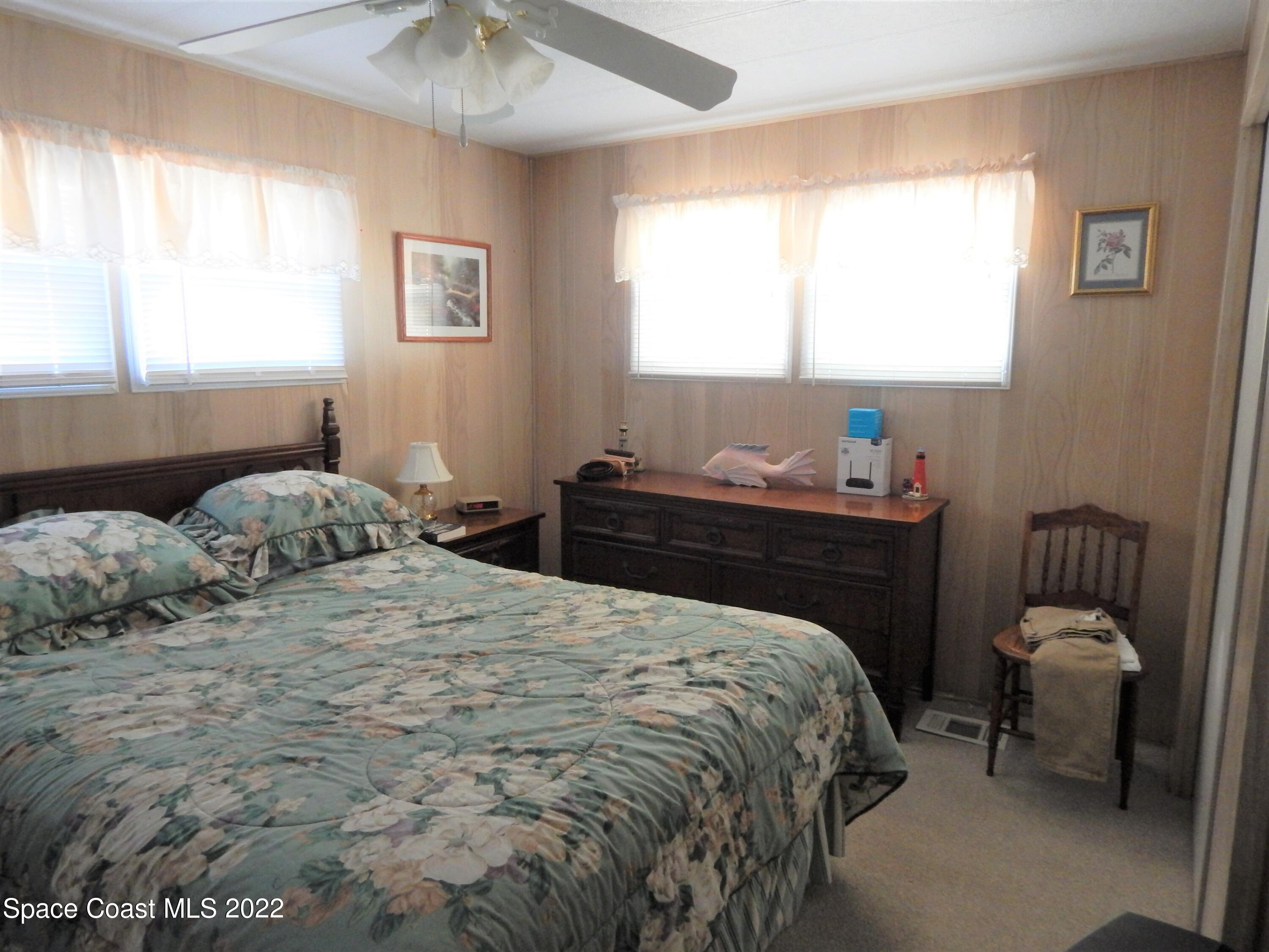 3112 Tangelo Drive Northeast Palm Bay, FL 32905 - Photo 18 of 42 a bedroom with a bed and a window