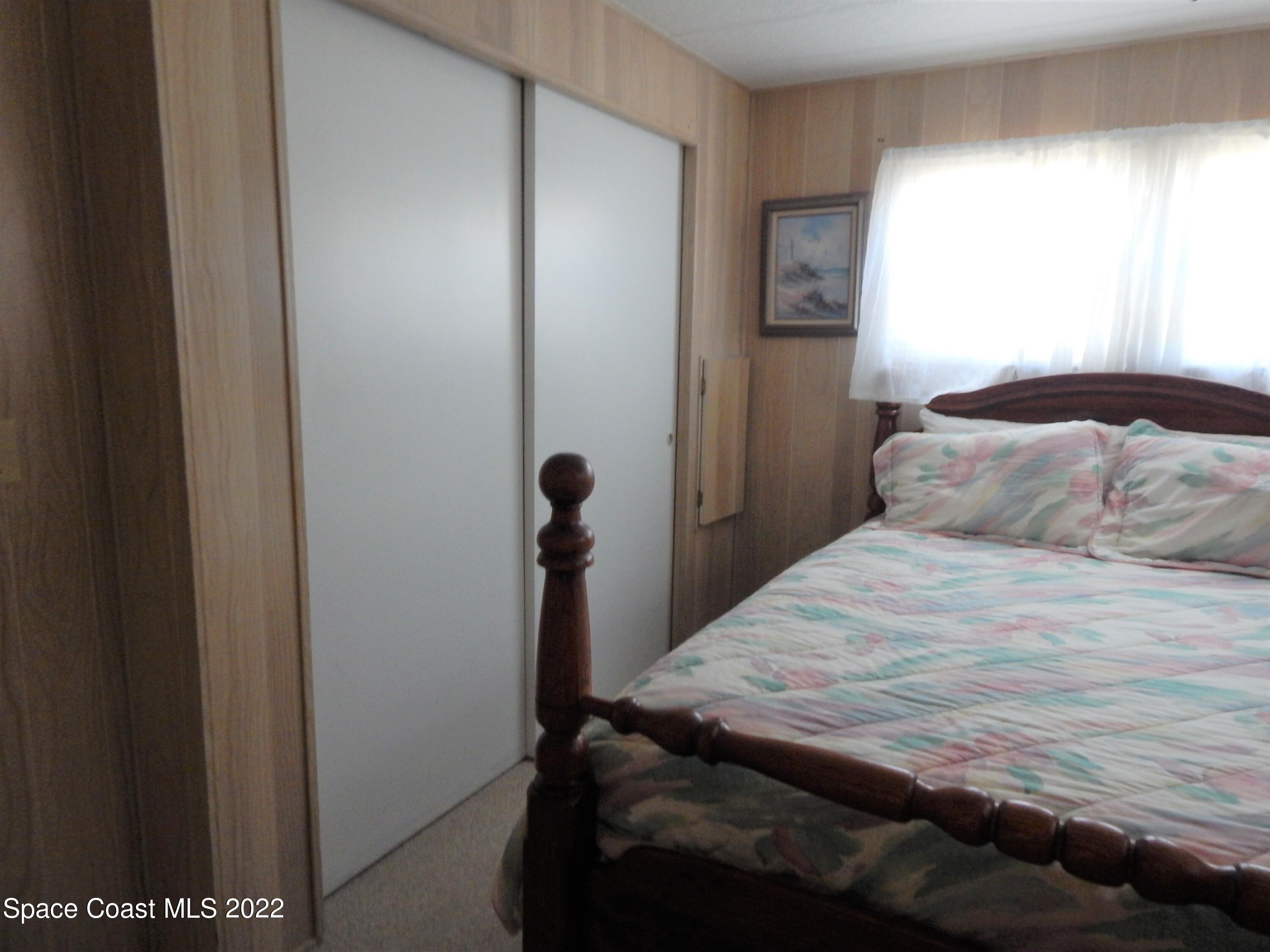 3112 Tangelo Drive Northeast Palm Bay, FL 32905 - Photo 19 of 42 a bedroom with a bed and a window