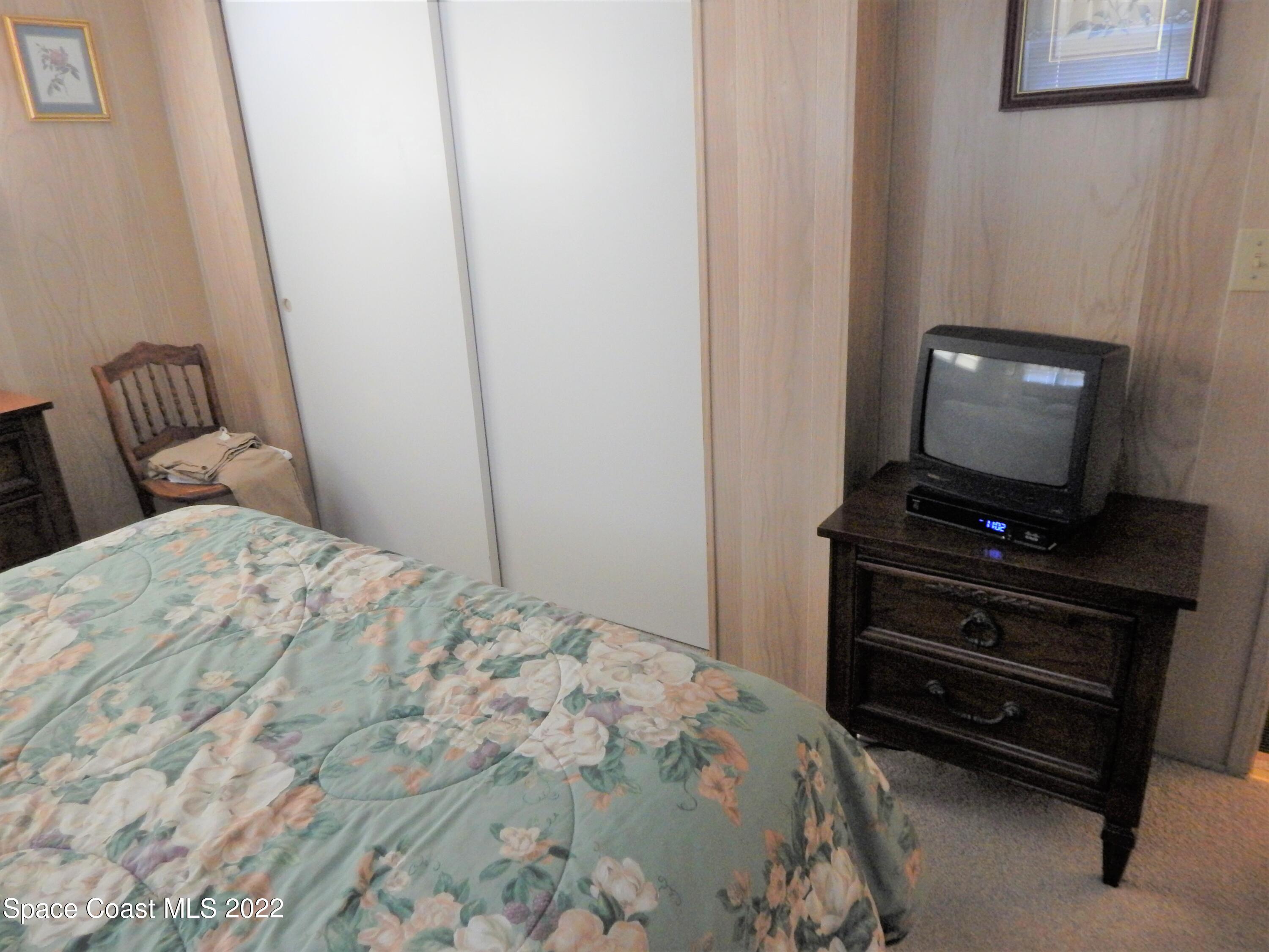 3112 Tangelo Drive Northeast Palm Bay, FL 32905 - Photo 20 of 42 a bedroom with a bed and a television