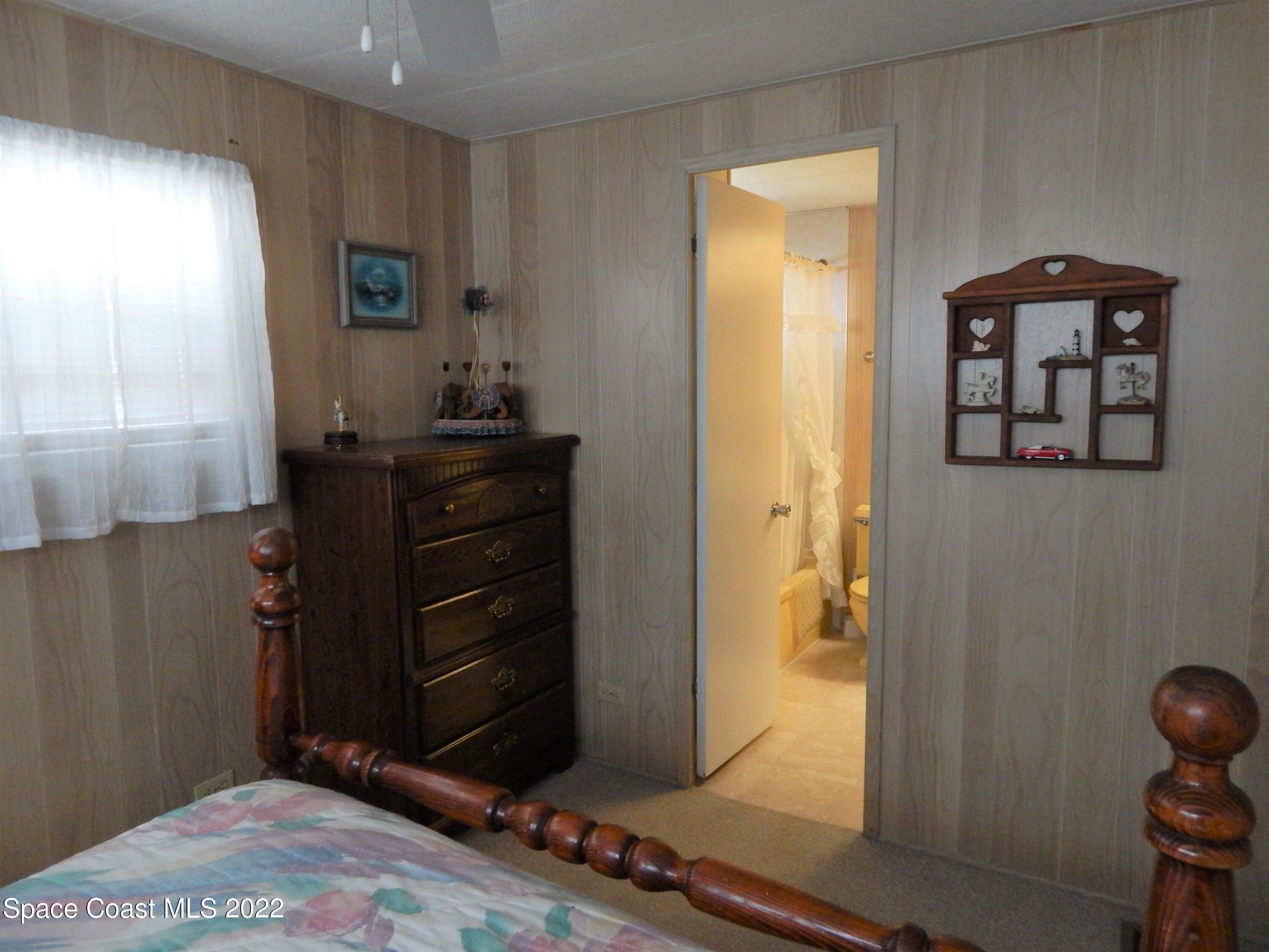 3112 Tangelo Drive Northeast Palm Bay, FL 32905 - Photo 22 of 42 a view of a hallway with wooden floor