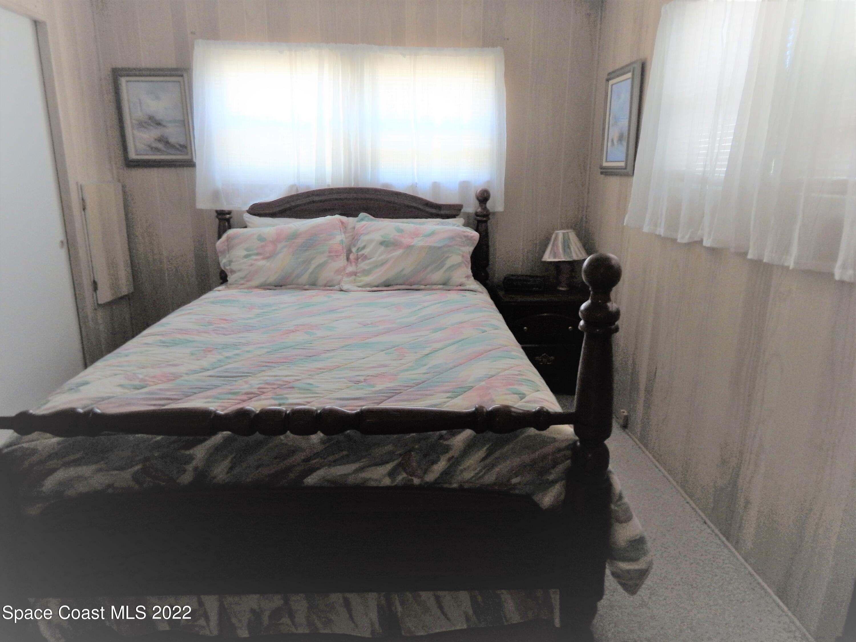 3112 Tangelo Drive Northeast Palm Bay, FL 32905 - Photo 23 of 42 a bedroom with a bed and a window