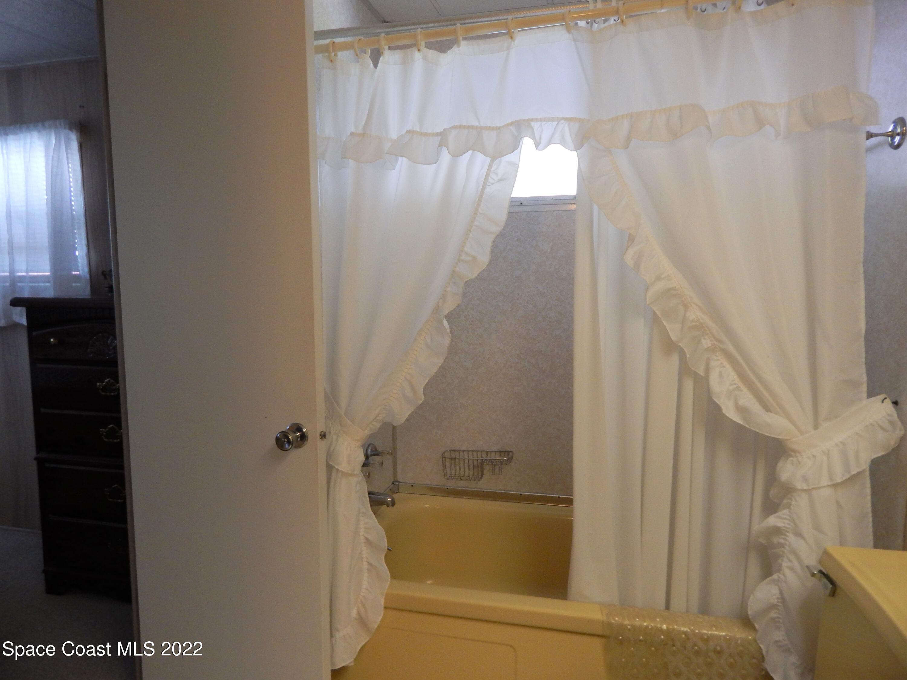 3112 Tangelo Drive Northeast Palm Bay, FL 32905 - Photo 25 of 42 a bathroom with a bathtub and shower