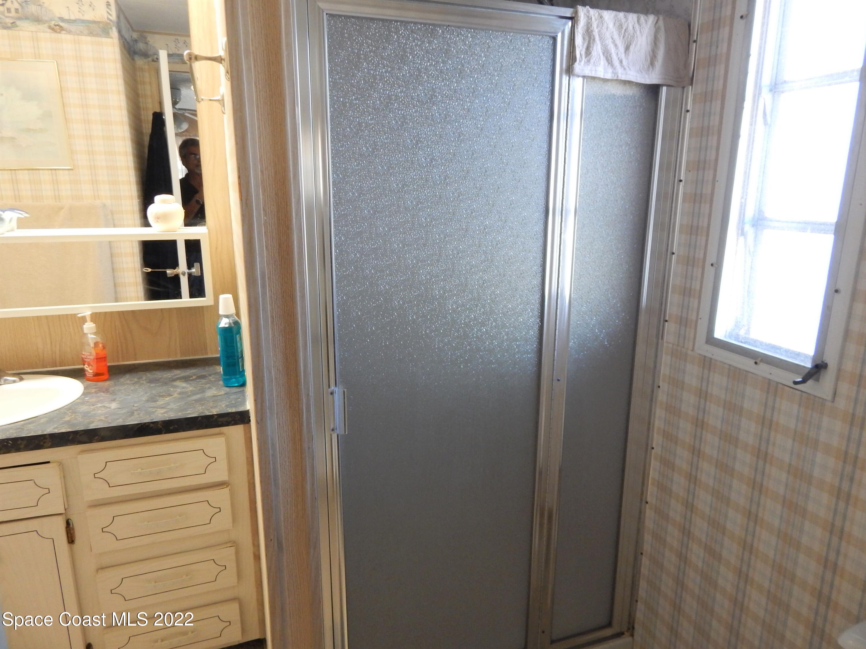 3112 Tangelo Drive Northeast Palm Bay, FL 32905 - Photo 26 of 42 a bathroom with a granite countertop shower and a sink