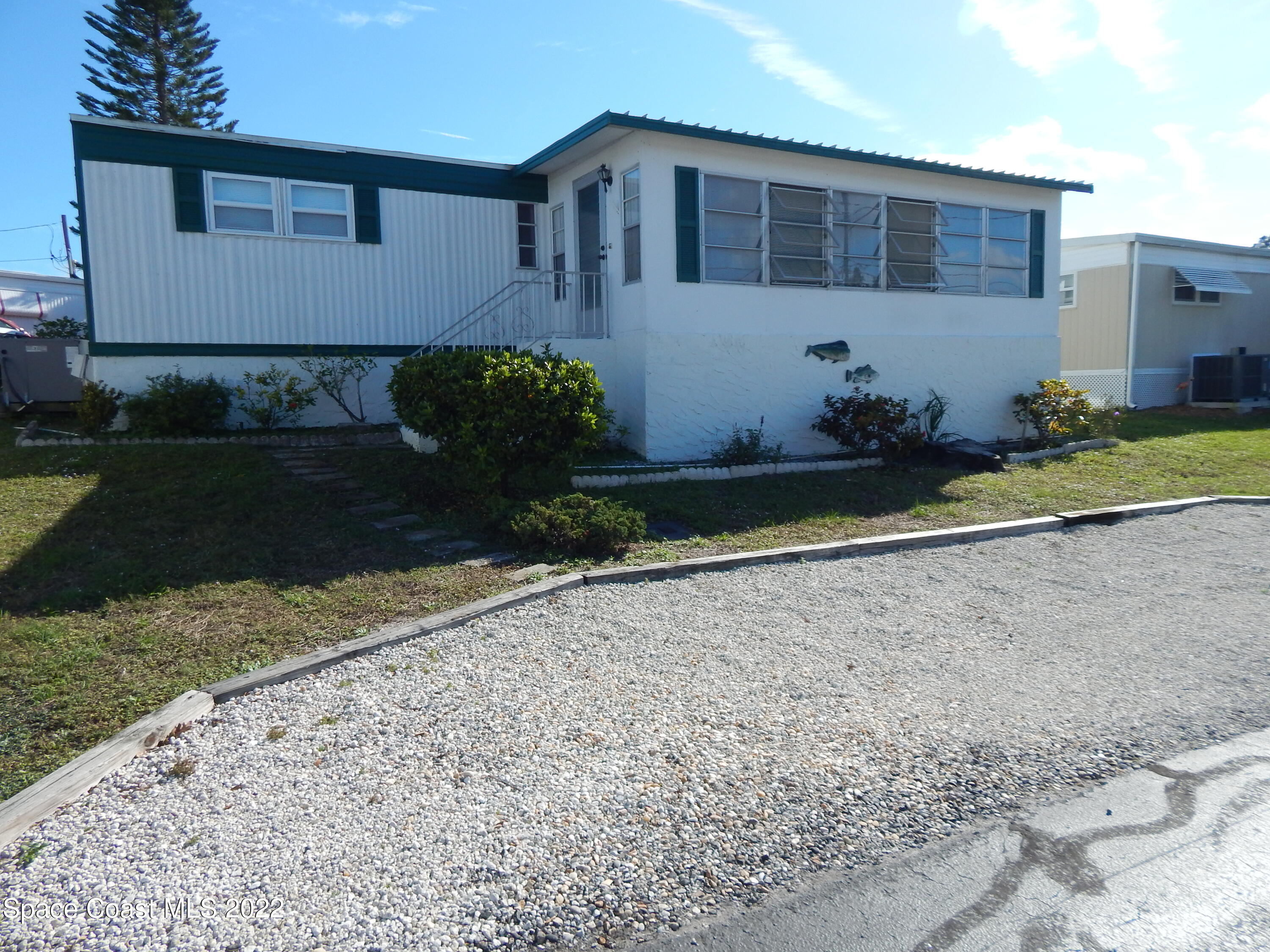3112 Tangelo Drive Northeast Palm Bay, FL 32905 - Photo 3 of 42 a front view of a house with a yard