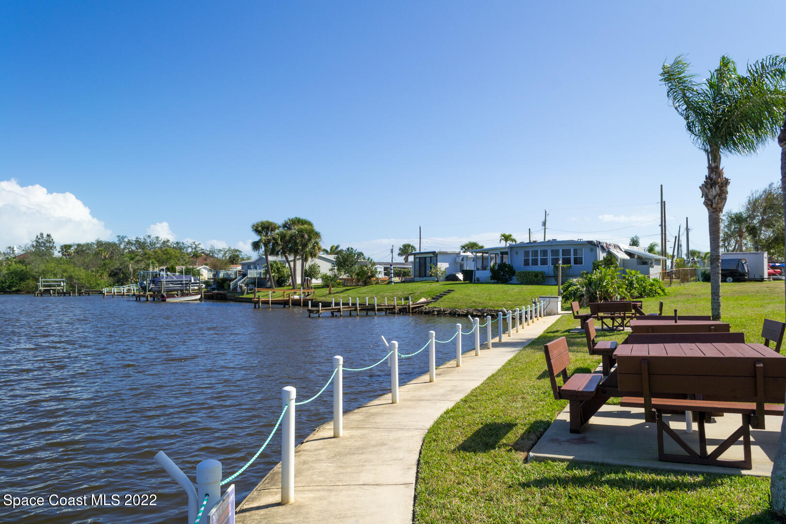 3112 Tangelo Drive Northeast Palm Bay, FL 32905 - Photo 33 of 42 a view of a lake with a table and chairs