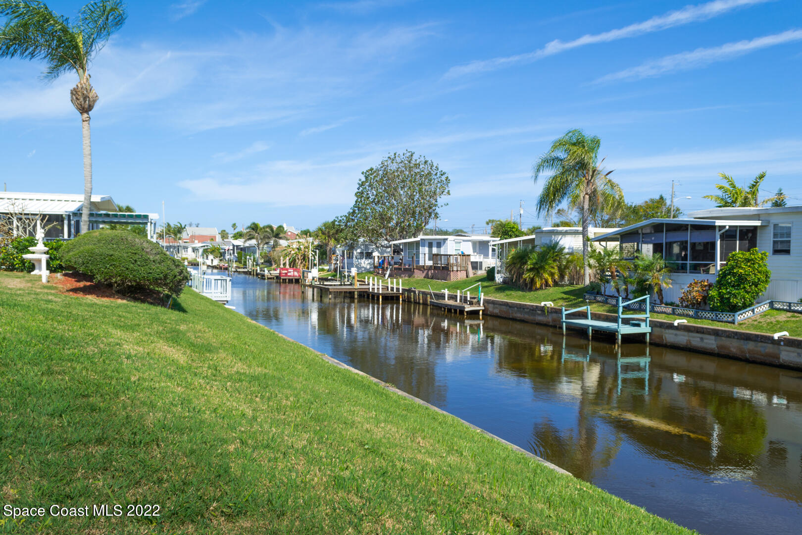 3112 Tangelo Drive Northeast Palm Bay, FL 32905 - Photo 37 of 42 a view of a lake with boats and trees in the background