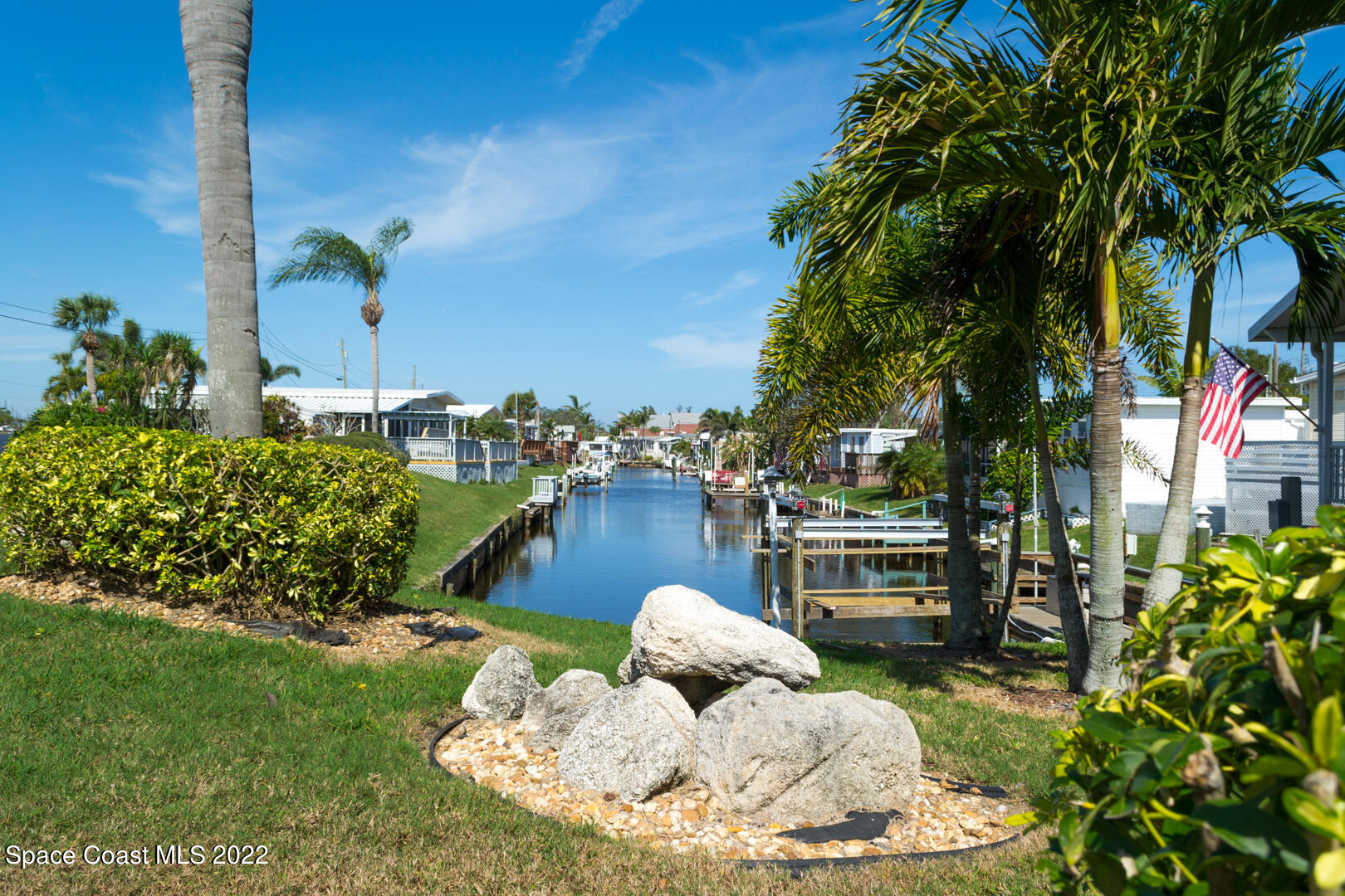 3112 Tangelo Drive Northeast Palm Bay, FL 32905 - Photo 42 of 42 a backyard of a house with table and chairs potted plants and lake view