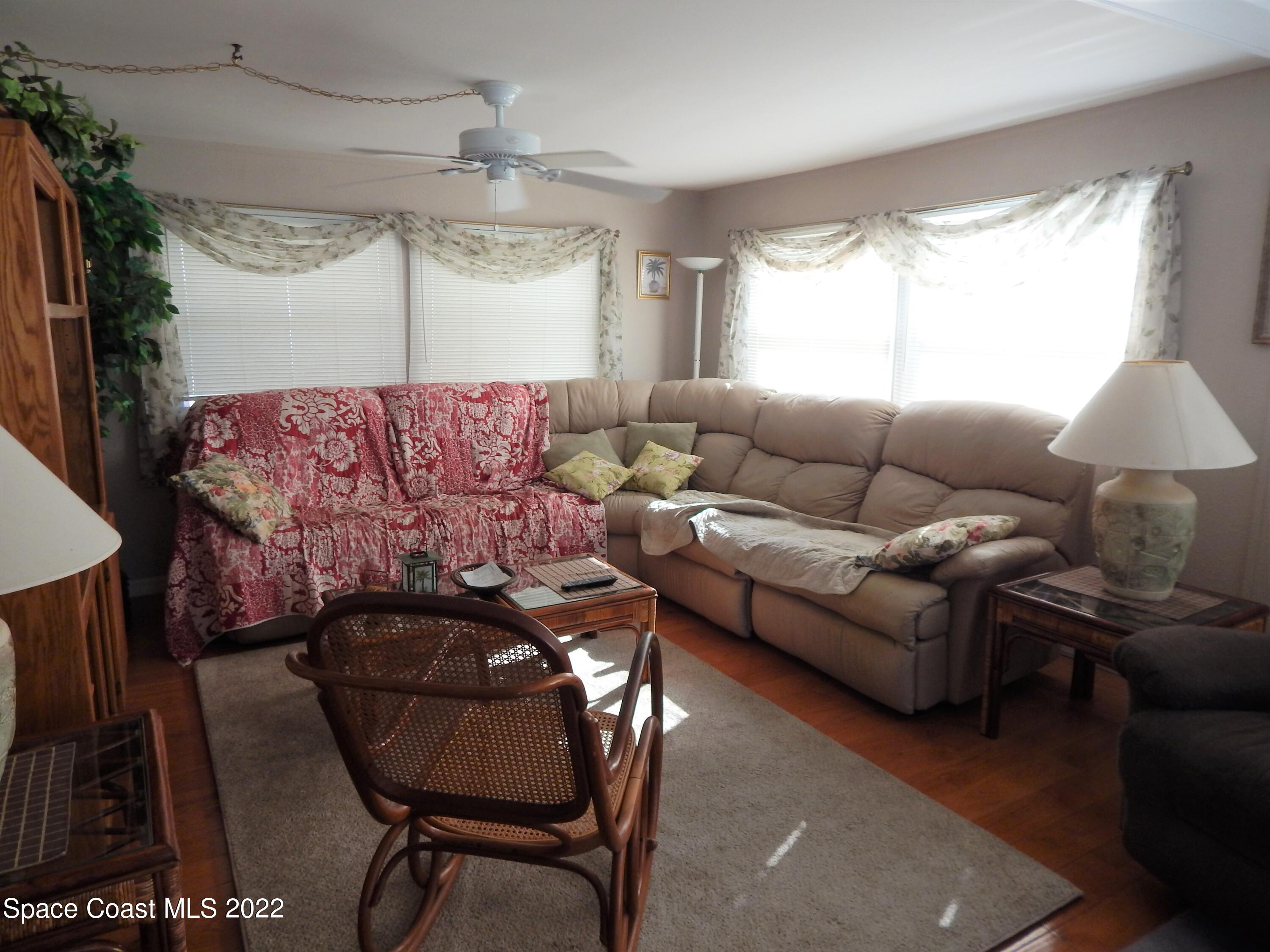 3112 Tangelo Drive Northeast Palm Bay, FL 32905 - Photo 10 of 42 a living room with furniture and a large window