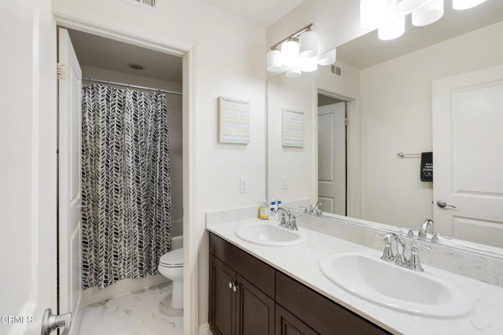 668 Whalen Way Oxnard, CA 93036 - Photo 24 of 57 a bathroom with a sink double vanity and a mirror