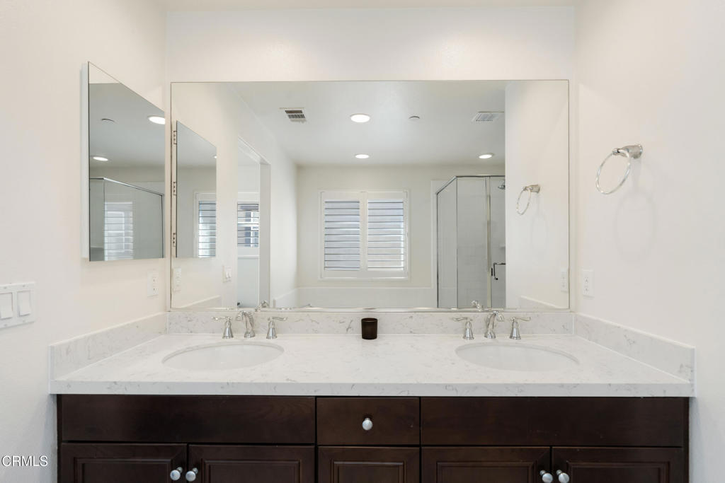 668 Whalen Way Oxnard, CA 93036 - Photo 28 of 57 a bathroom with double vanity sinks and a mirror