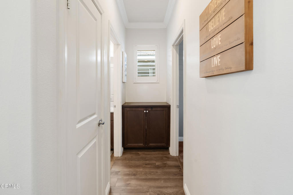 668 Whalen Way Oxnard, CA 93036 - Photo 7 of 57 a view of a hallway with wooden cabinets and a window