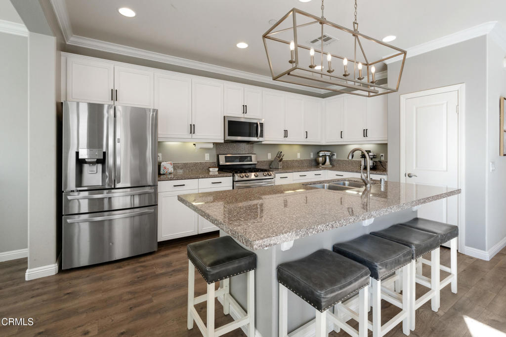 668 Whalen Way Oxnard, CA 93036 - Photo 9 of 57 a kitchen with stainless steel appliances granite countertop a refrigerator a microwave a sink and a stove