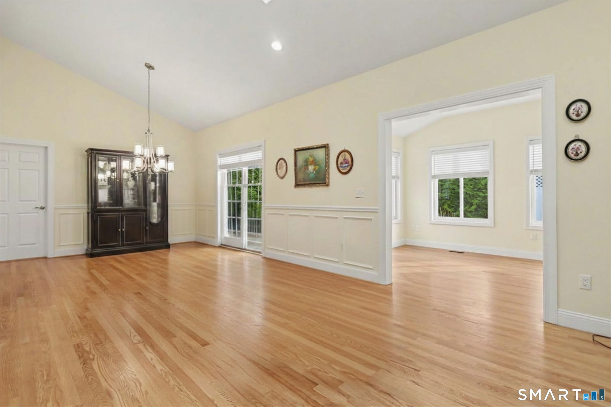 223 Meadow Brook Road, Unit 223 Oxford, CT 06478 - Photo 9 of 34 an empty room with wooden floor and windows