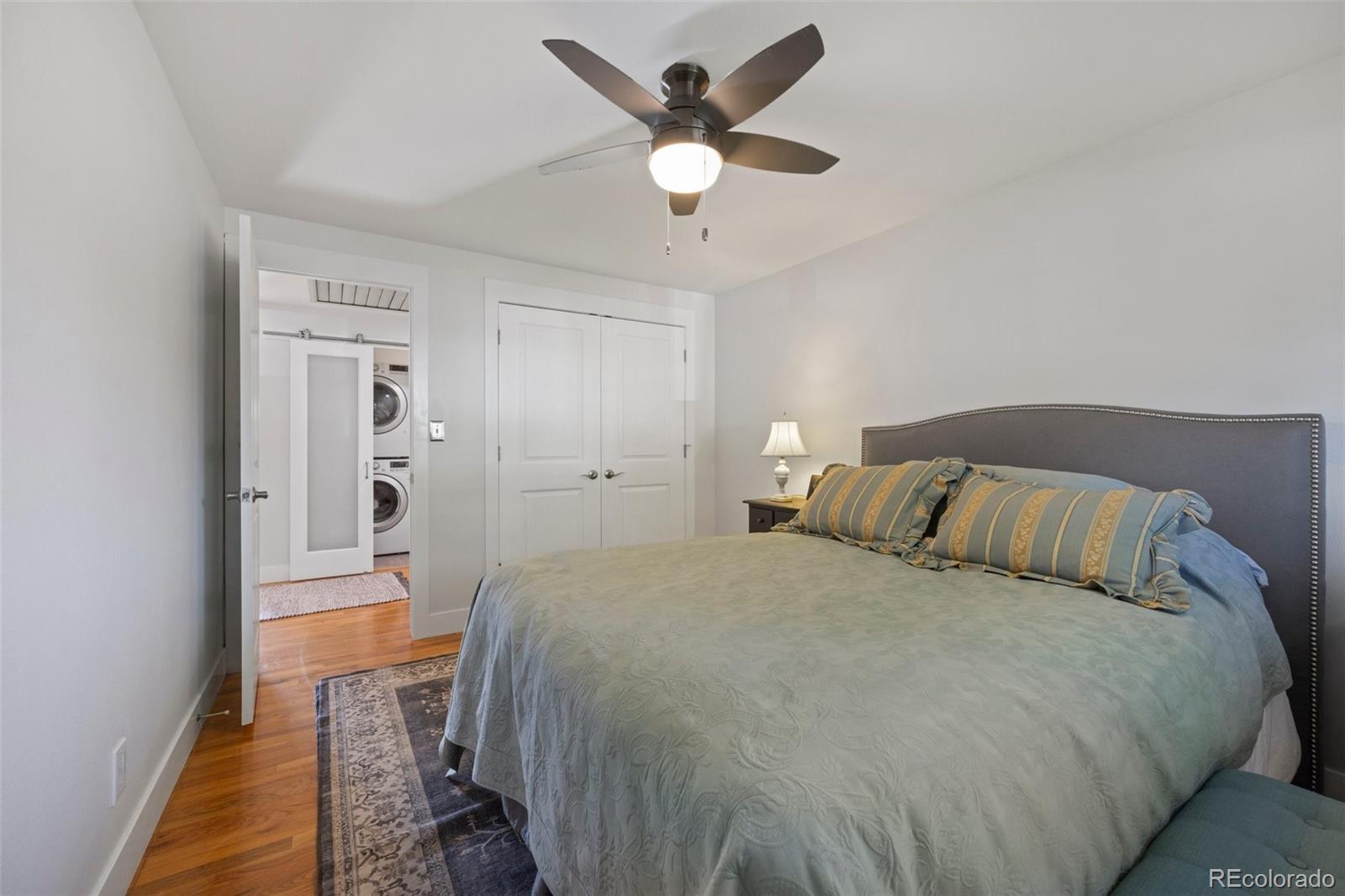 703 South Oneida Way Denver, CO 80224 - Photo 16 of 24 a bedroom with a bed and a ceiling fan