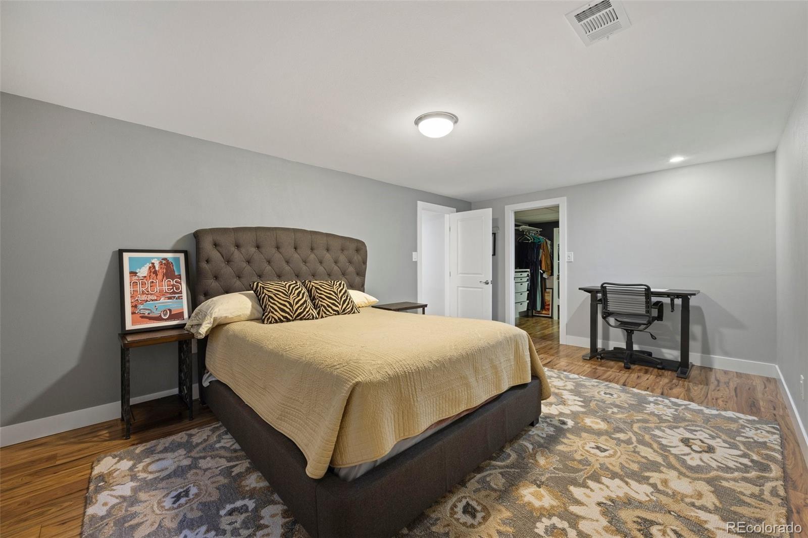 703 South Oneida Way Denver, CO 80224 - Photo 18 of 24 a bedroom with a bed table and two chairs